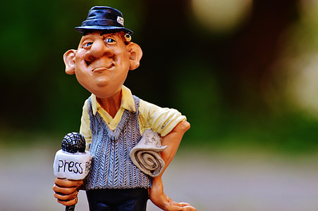 shallow focus photography of brown-haired man holding white microphone bobblehead display figure thumbnail