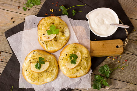 three round pastries served on board with dip thumbnail