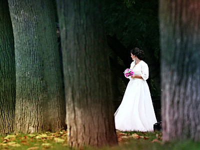 woman in white wedding dress holding pink boquet thumbnail