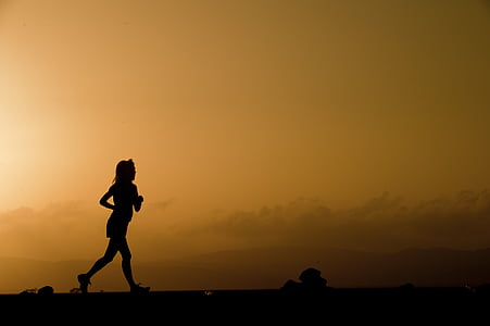 silhouette of woman running during golden hour thumbnail