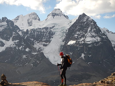 man standing in front of grey snow mountain thumbnail
