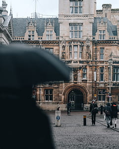 man walking near brown concrete building thumbnail