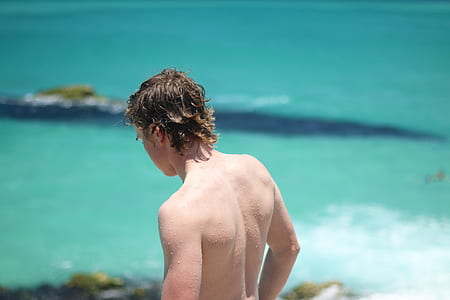 topless man near body of water thumbnail