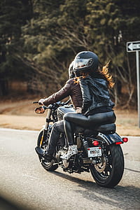 man and woman riding on motorcycle in road thumbnail