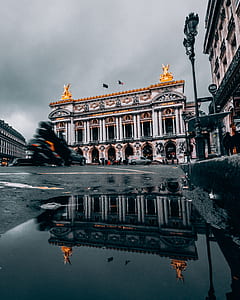 white and orange building under gray sky thumbnail