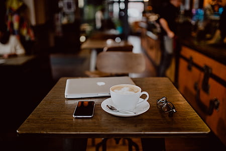 Cup of coffee on table in cafe thumbnail