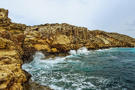sea wave splashing on seashore during daytime thumbnail