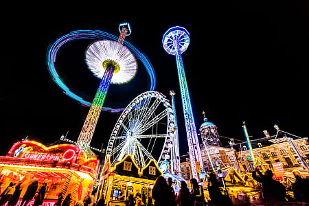 low-angle photography of peole in a carnival at night thumbnail