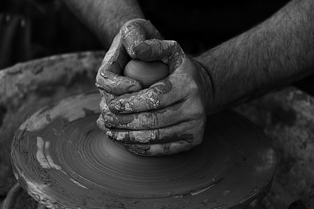 person holding a clay thumbnail