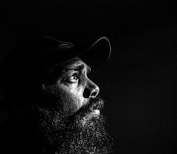 man with black beard wearing black cap on grayscale photography thumbnail