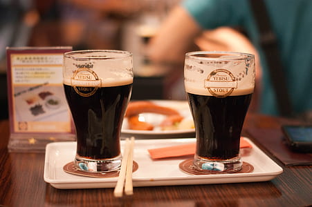 two filled glasses on white tray thumbnail