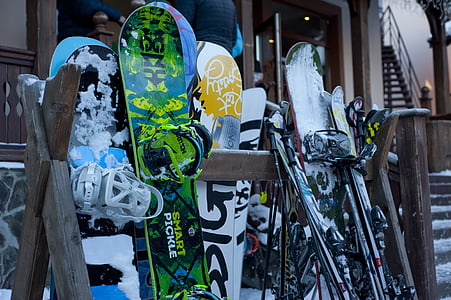 assorted-color snowboards and ski boards on rack thumbnail