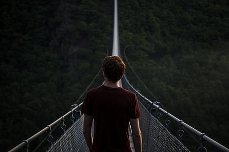 man on hanging bridge at daytime thumbnail