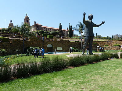 black statue near brown wall thumbnail