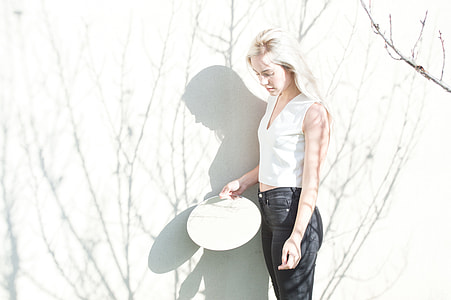 woman holding white hand fan thumbnail
