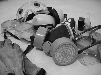 grayscale photo of gas mask beside gloves thumbnail
