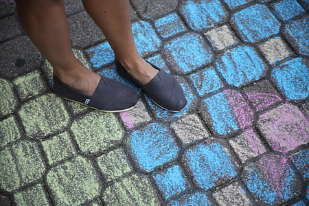person standing on assorted-color pavement blocks thumbnail