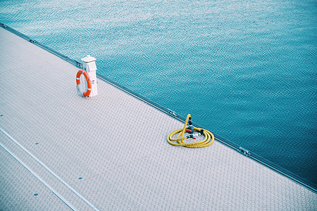 yellow hose beside water thumbnail