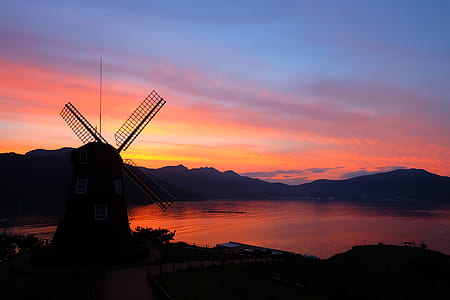 windmill near body of water thumbnail