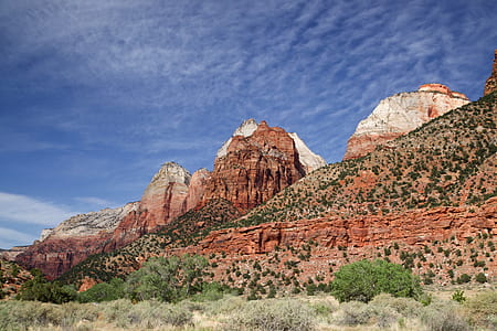 brown mountain under cloudy sky thumbnail