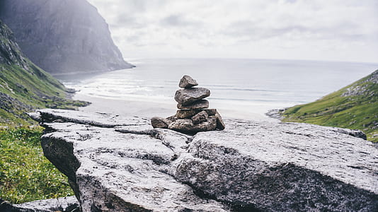 gray cairn stones under cloudy sky thumbnail