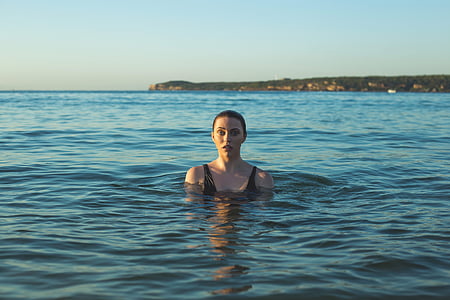 woman in rippling body of water during daytime thumbnail