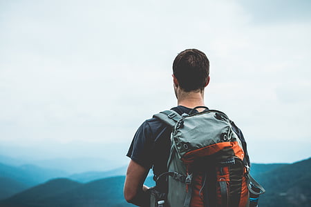 man with backpack on top of mountain thumbnail