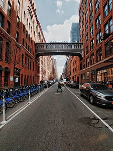 person walking on road near bicycle and vehicle thumbnail