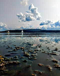 body of water near mountain thumbnail