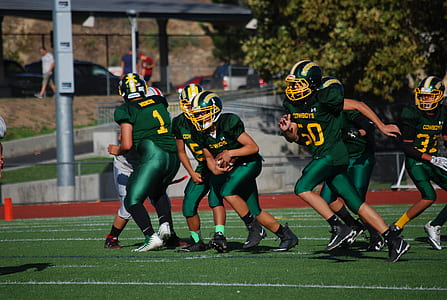 football player playing on field during daytime thumbnail