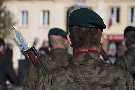 selective focus photo of man in camouflage suit holding rifle thumbnail