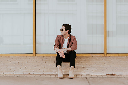 man wearing red suit jacket during daytime thumbnail