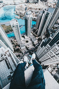 aerial photography of person sitting on top of building thumbnail