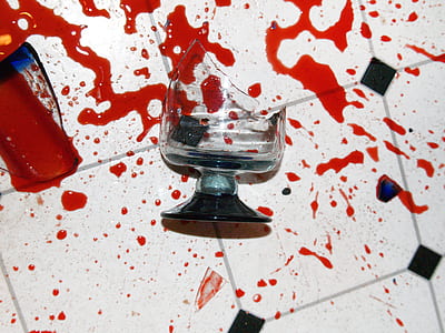 broken footed glasses with red tint scattered on floor thumbnail