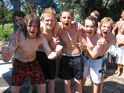 group of boys smiling near trees during daytime thumbnail