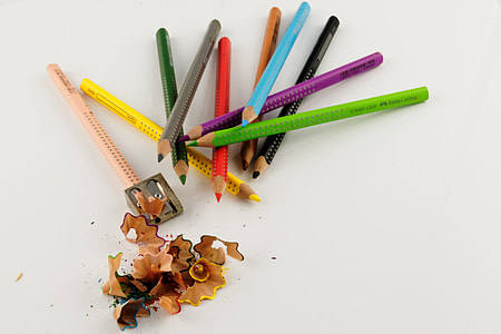 sharpened color pencil and pile of color pencils on white surface thumbnail