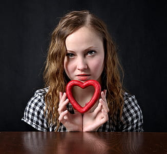 woman holding red heart decor thumbnail