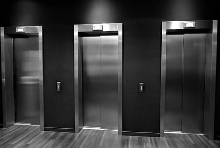 three grey stainless steel elevator doors thumbnail