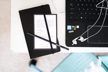 black pen beside laptop computer thumbnail