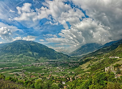 village in between mountain range during daytime thumbnail