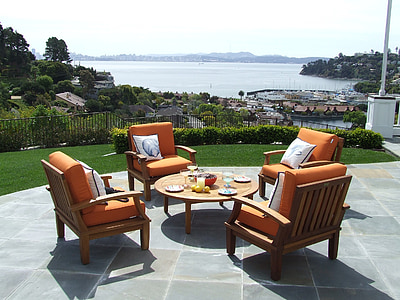 round brown wooden table and chairs on gray floor tiles thumbnail