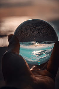 Person Holding Ball Showing Seashore thumbnail