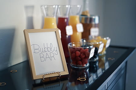 Brown Photo Frame Beside Drinking Glass With Fruit Inside thumbnail