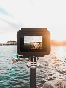 black action camera capturing ocean waves thumbnail