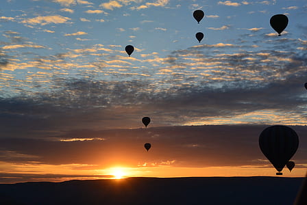 silhouette of hot air balloons at golden hour thumbnail
