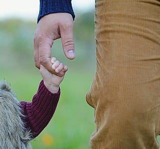 child and person holding hands thumbnail