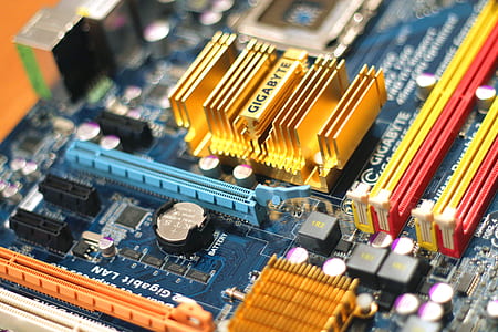 On this photo a computer mainboard manufactured by Gigabyte is visible. It features different sockets, connectors, coolers, heatpipes, the mainboard battery, DDR memory ram slots and the processor socket. thumbnail