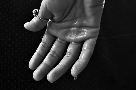 grayscale photography of person's hand wearing ring thumbnail