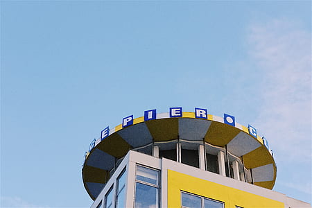 yellow and white pier building under clear skies thumbnail
