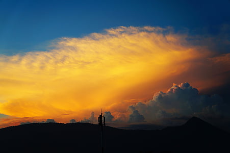 building under yellow clouds thumbnail